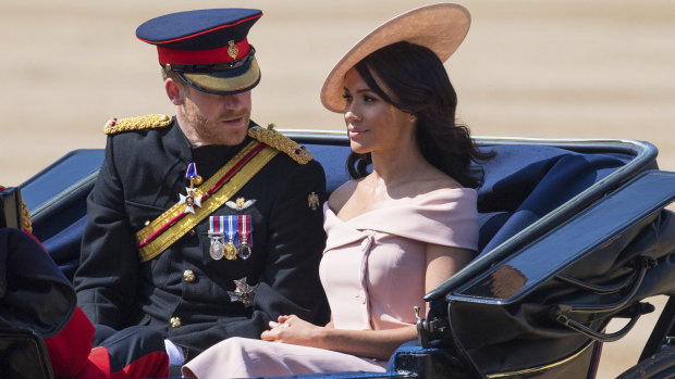 Prince Harry and Meghan, the Duchess of Sussex, ride in a carriage during the Trooping the Colours ceremony as the Queen celebrates her official birthday in London.