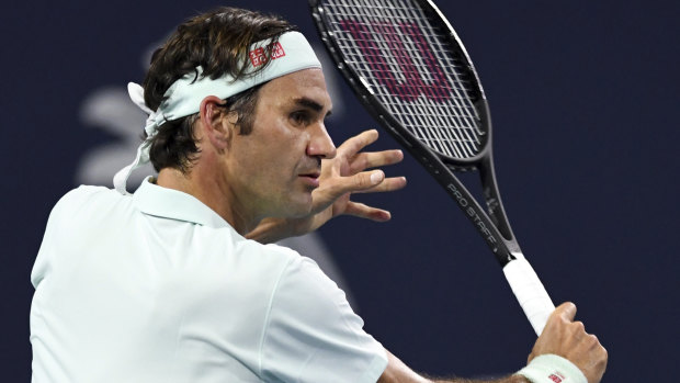Swiss Roger Federer hits a return to Denis Shapovalov of Canada in the Miami Open semi-final. 