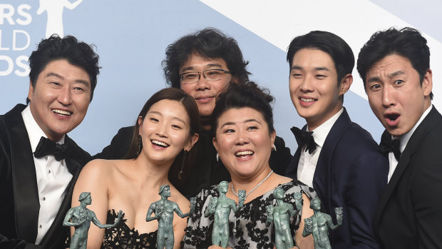 Kang-Ho Song, from left, Park So-dam, Bong Joon-ho, Jang Hye-jin, Choi Woo-shik, and Lee Sun Gyun of <i> Parasite </i>.