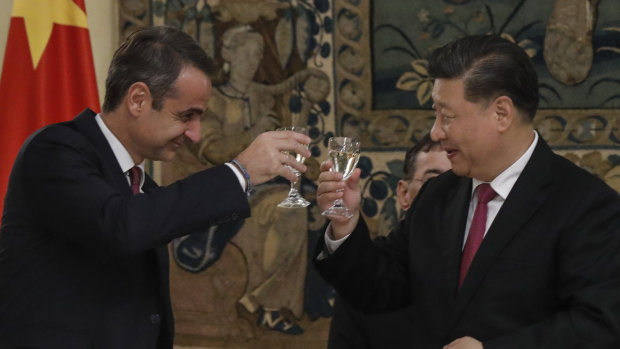 Chinese President Xi Jinping, right, and Greek Prime Minister Kyriakos Mitsotakis toast during a state dinner at the Greek presidential palace in Athens.