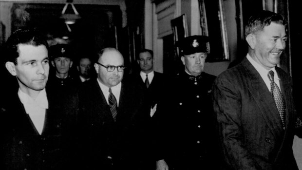 The Serjeant-at-Arms, Jack Pettifer (left) escorts Frank Browne (wearing spectacles) and Raymond Fitzpatrick (in front) from King's Hall, Parliament House, after the House of Representatives had ordered that they be imprisoned for three months. 