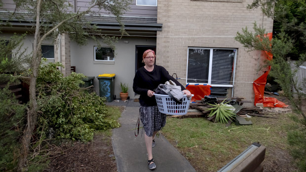Sarah Burgess leaves her Seaford home after a car crashed into her lounge room.