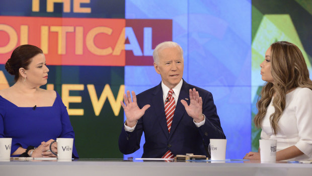 This image released by ABC shows Democratic presidential candidate Joe Biden, center, with co-hosts, Ana Navarro, left, and Sunny Hostin during an appearance on "The View." 