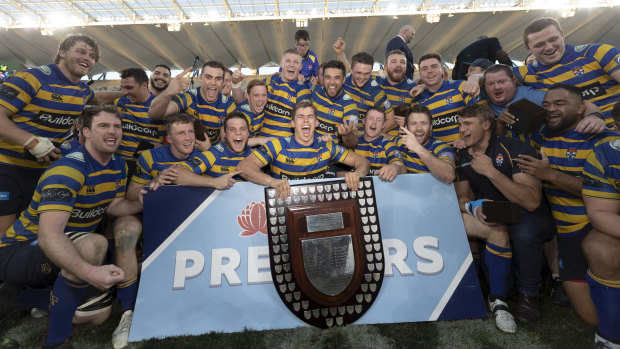 Swinton celebrates with Sydney University teammates after winning last year's Shute Shield title. 