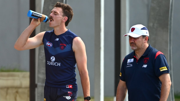 Jake Lever walks off the training track after a fainting episode.