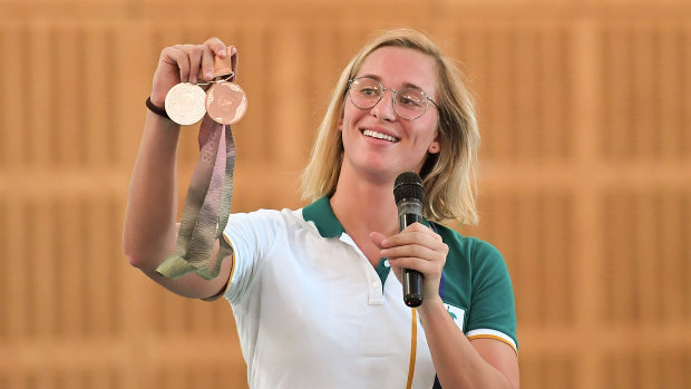 Maddie Groves displays her Olympic medals to students in 2019.