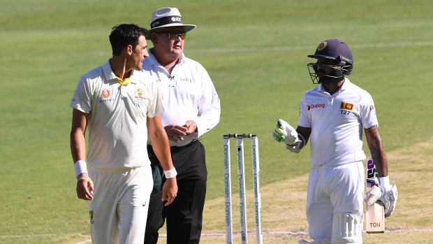 Blunted: Sri Lankan batsman Niroshan Dickwella and the out-of-sorts Mitchell Starc have words during day three.