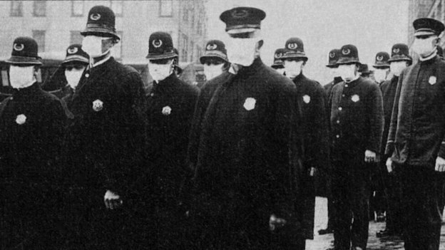 Seattle police wear protective masks during the 1918 flu pandemic, which killed tens of millions.