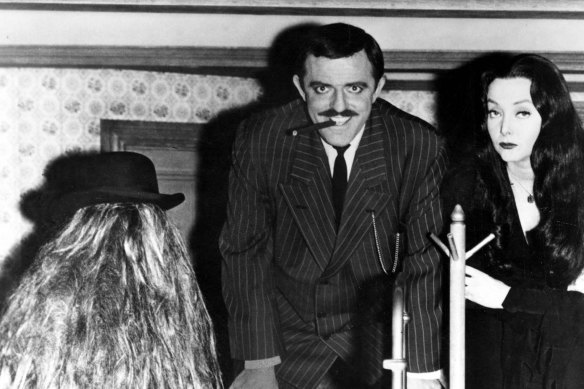 Cousin Itt (Felix Silla), Gomez (John Astin) and Morticia Addams (Carolyn Jones) in the original Addams Family TV series.