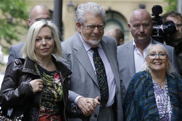 Rolf Harris arrives with his daughter Bindi, left, and wife Alwen Hughes at Southwark Crown Court in London in May 2014.