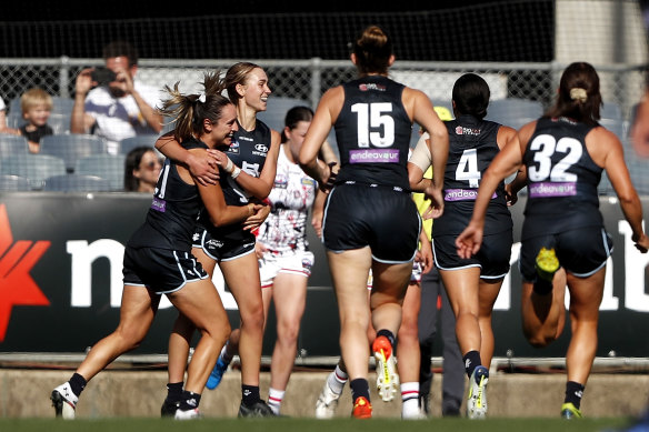 Keeley Sherar celebrates a goal with Blues teammates.