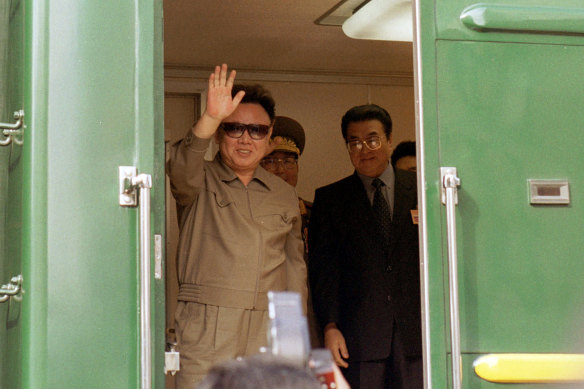 Kim Jong-il waves during a train journey back to North Korea from Russia in 2001.