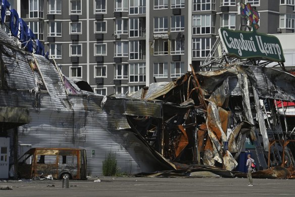 A man is dwarfed by the ruins of one of the many buildings impacted by Russian shelling and missiles in Bucha. 