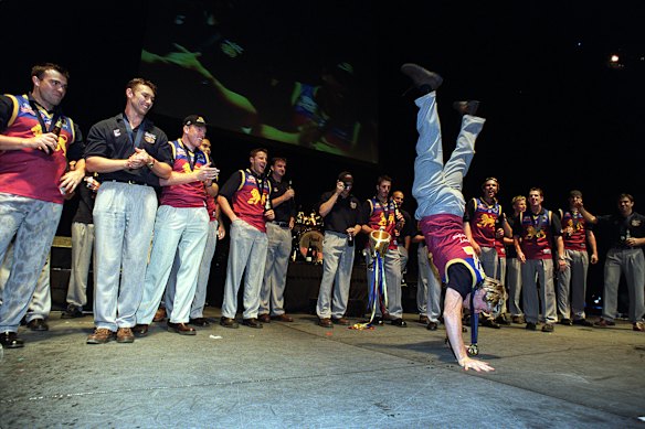 Jason Akermanis performing a handstand at Brisbane’s grand final celebrations.
