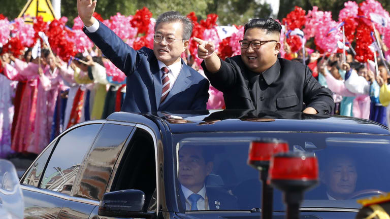 South Korean President Moon Jae-in, left, and North Korean leader Kim Jong-un ride in a car parade through Pyongyang in North Korea. 