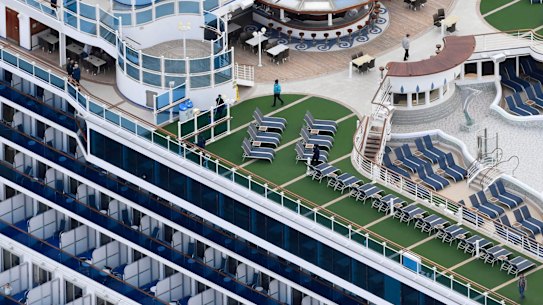 A cruise ship Diamond Princess anchors off the Yokohama Port upon arrival in Yokohama near Tokyo Tuesday, Feb. 4, 2020. A person who was a passenger on the Japanese-operated cruise ship has tested positive for a new virus after leaving the ship in Hong Kong on Jan. 25. The ship returned to Yokohama carrying 3,000 passengers and crew members after making port calls in Vietnam, Taiwan and Okinawa. A team of quarantine officials and medical staff boarded the ship on Monday night and began medical checks of everyone on board, a health ministry official said on condition of anonymity, citing department rules. (Kyodo News via AP)