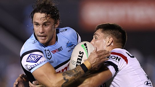 Nicho Hynes is tackled by Victor Radley.