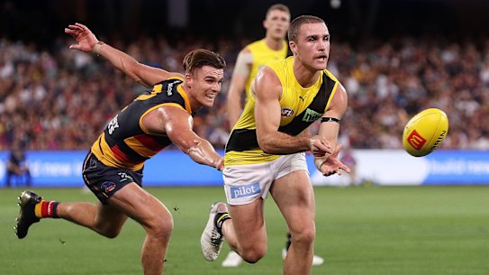 Jack Ross looks to evade Crows opponent Ben Keays in their round five clash.