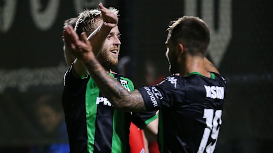 Adding to the tally: Connor Pain celebrates with teammate Josh Risdon (right) after doubling Western United's lead.