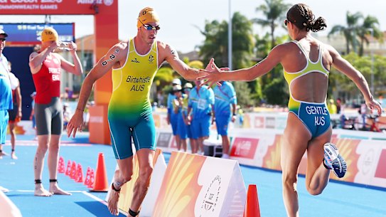 Australians Jake Birtwhistle and Ashleigh Gentle change over during the triathlon mixed team relay at the Gold Coast Commonwealth Games in 2018. 