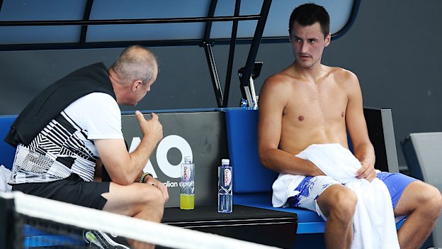 John Tomic talks to his son during the 2018 Australian Open.