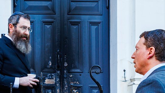 Rabbi Dovid Gurnick speaks to Dvir Abramovich outside the East Melbourne synagogue on Saturday.