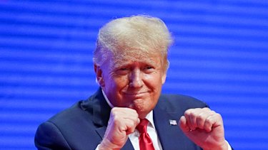 Donald Trump acknowledges support after speaking at the conference on Saturday.
