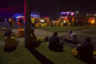 RFS crews take a break after fighting the Liberation Trail fire outside Nana Glen on Tuesday night. 