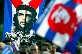 Cubans hold a poster of Ernesto “Che” Guevara during a Havana demonstration, 2003.