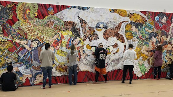 Staff at Takashi Murakami’s studio in Saitama, Japan, work on the detailed decorative surface of Murakami’s new work for the Art Gallery of NSW.