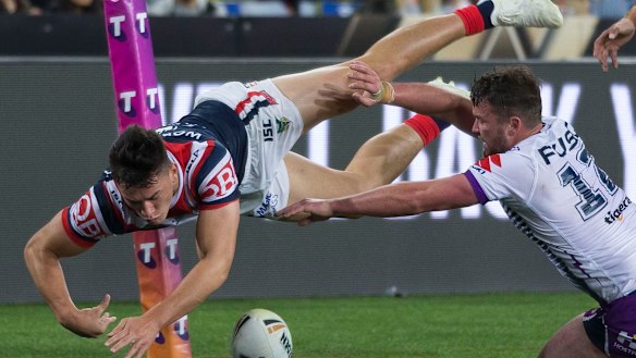 Star performer: Joseph Manu crosses out wide in the first half for the Roosters.