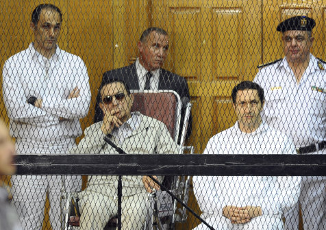 Egyptian President Hosni Mubarak, seated centre left, and his two sons, Gamal Mubarak, left, and Alaa Mubarak attend a hearing in a courtroom in Cairo, Egypt, 2013.
