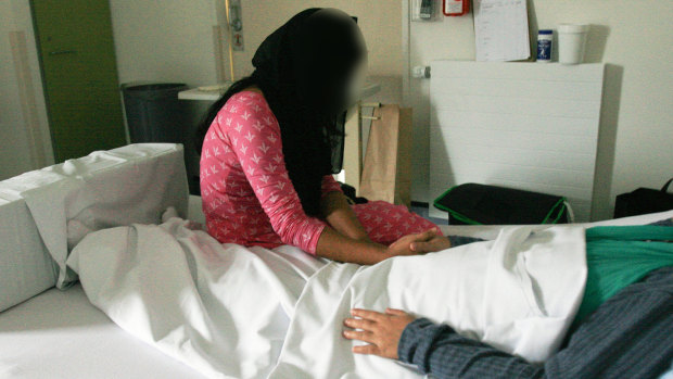 Sazada Akhter's sister, Nahida Akhter, left, visits her in hospital last week.