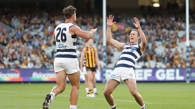 Tom Hawkins (L) and Mitch Duncan of the Cats celebrate.