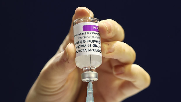 Clinical staff prepare a dose of the AstraZeneca COVID-19 vaccine. 