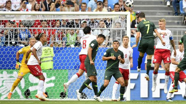 Head and shoulders above: Mathew Leckie beats the Danish defence to get a clear header towards goal, as Australia took the game to the world no.12 side.
