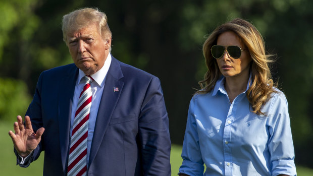US President Donald Trump waves while walking with first lady Melania Trump at the White House on Sunday. In his first verbal response to the two mass shootings over the weekend, Trump said "hate has no place" in this country. 
