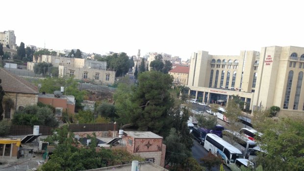 The Leonardo Hotel (right) is in what was no man's land between East and West Jerusalem after the 1949 armistice lines were drawn. Across the street full of tour buses is the back of St George's School, where my father was a boarder. 