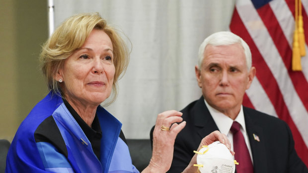 Dr Deborah Birx, White House coronavirus response co-ordinator, holds a 3M N95 mask as Vice-President Mike Pence looks on during a visit to the 3M headquarters in Maplewood, Minnesota. 