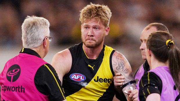 Nathan Broad is helped from the ground on Friday night.