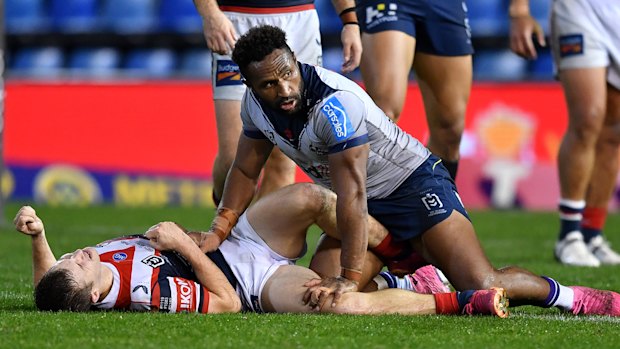 Sydney Roosters halfback Sam Walker after getting hit by Melbourne Storm centre Justin Olam.