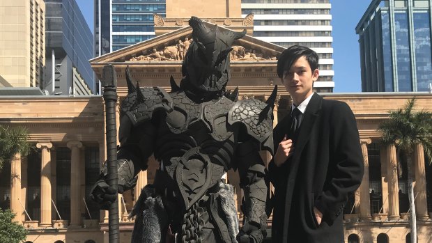 Designer Max Milann (right) and costume maker Romeo Lazarus take to the streets of Brisbane with one of the  seven deadly sins.