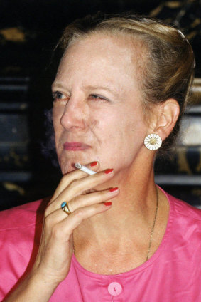 Queen Margrethe II of Denmark smokes a cigarette in 1991.