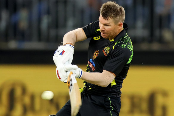 David Warner hits a six on the way to 73 from 44 balls against England in Perth on Sunday.
