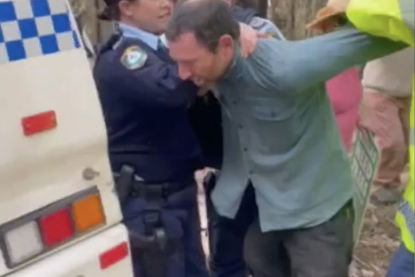 A still from a vidoe of Graham being arrested at a protest.