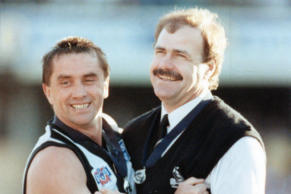 Matthews with Collingwood premiership captain Tony Shaw after their grand final win in 1990.