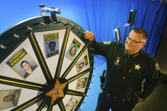Brevard County Sheriff Wayne Ivey gets ready to spin his popular “Wheel of Fugitive” in Titusville, Florida.