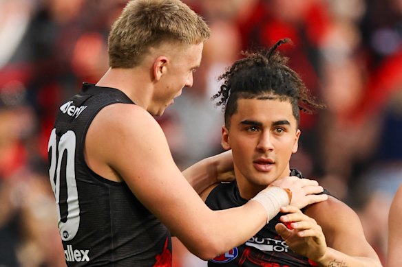 Isaac Kako celebrates a goal with Nate Caddy on Anzac Day.