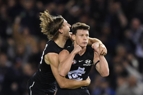 Sam Walsh, right, pictured celebrating a goal in round 20 last year, has been elevated to Carlton's leadership group.