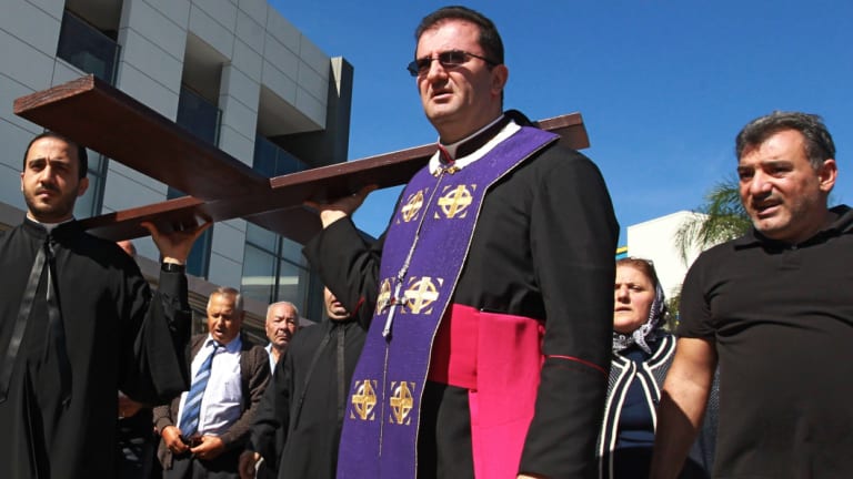 Bishop Tarabay leads a procession at the Good Friday Mass of Our Lady of Lebanon Church, Harris Park, in 2014. 